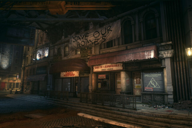 Des logements et boutiques en partie abandonnées. Sur la banderole on peut lire "Sauvez nos foyers". Sur la droite se trouve le cabinet de John Constantine.